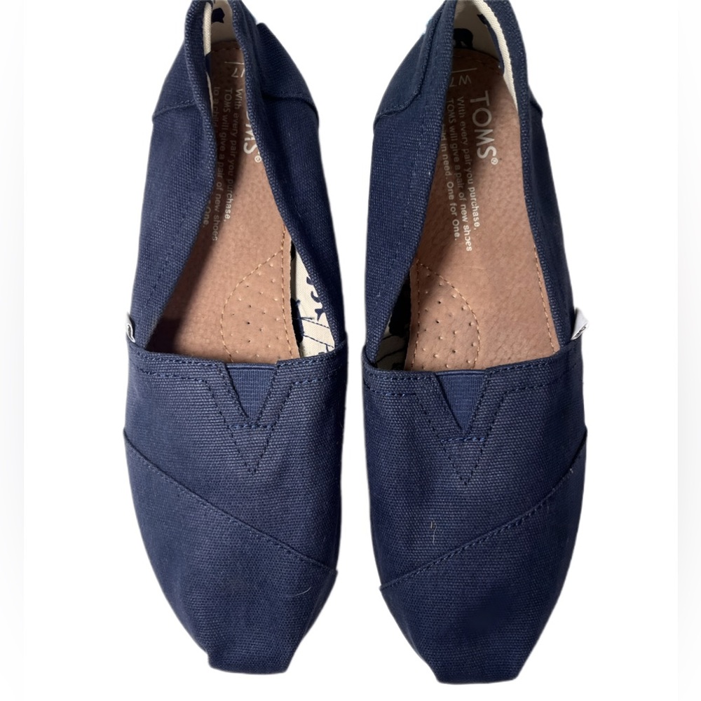 TOMS 7 flats brand new! Royal blue on outside. Dinosaur pattern on inside